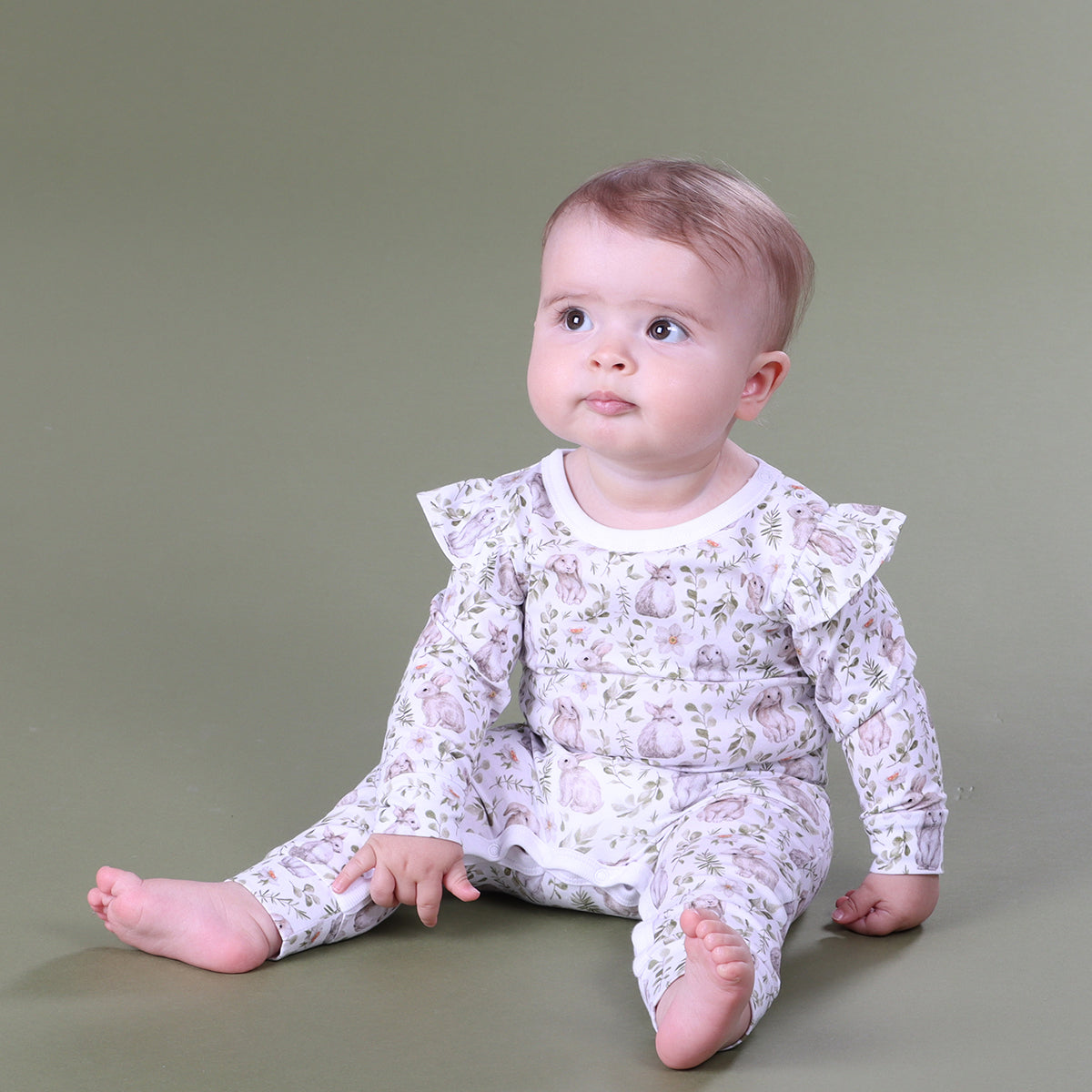 Baby girl sitting while Little bee by Dimples Cotton Frill Babygorw with bunny print