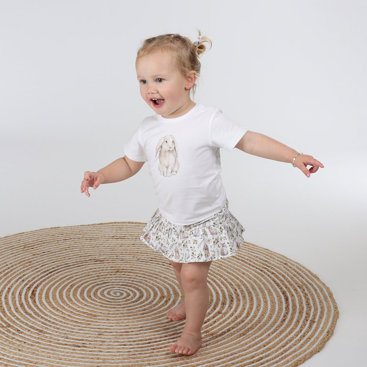 little girl running around while wearing Little Bee By Dimples Bunny Cotton Skirt