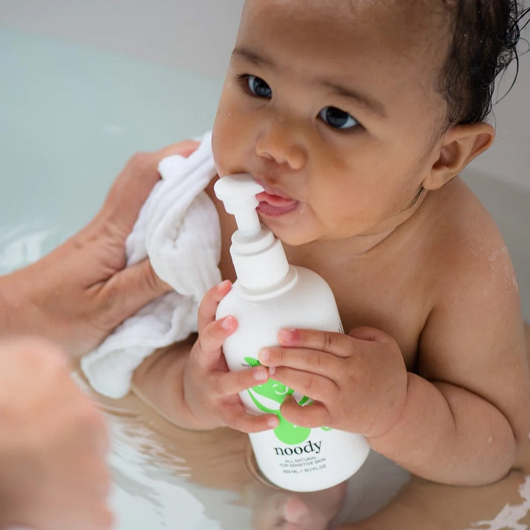 Baby in shower with Soft Clouds bath and body wash