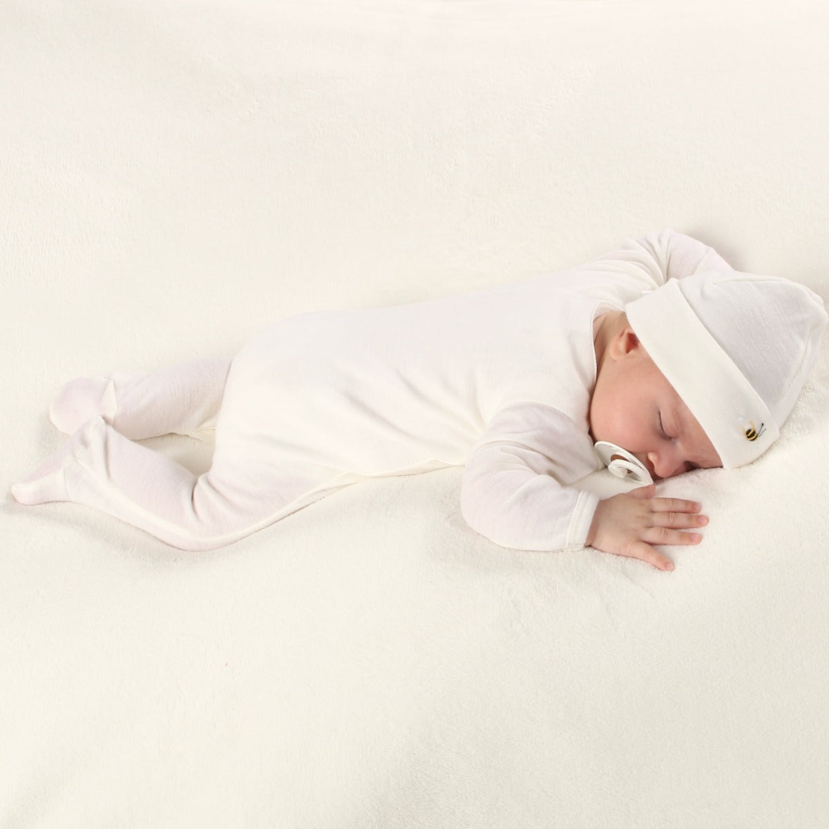 Dimples Classic merino Babygrow in cream Bee on sleeping baby