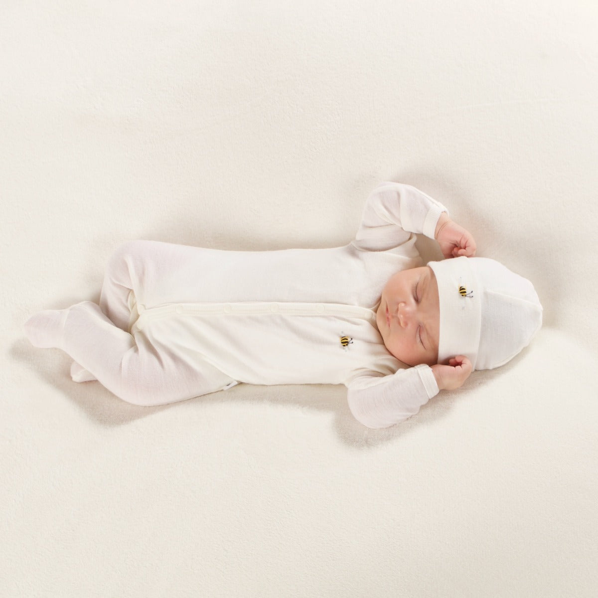 Dimples Classic merino Babygrow in cream Bee on sleeping baby