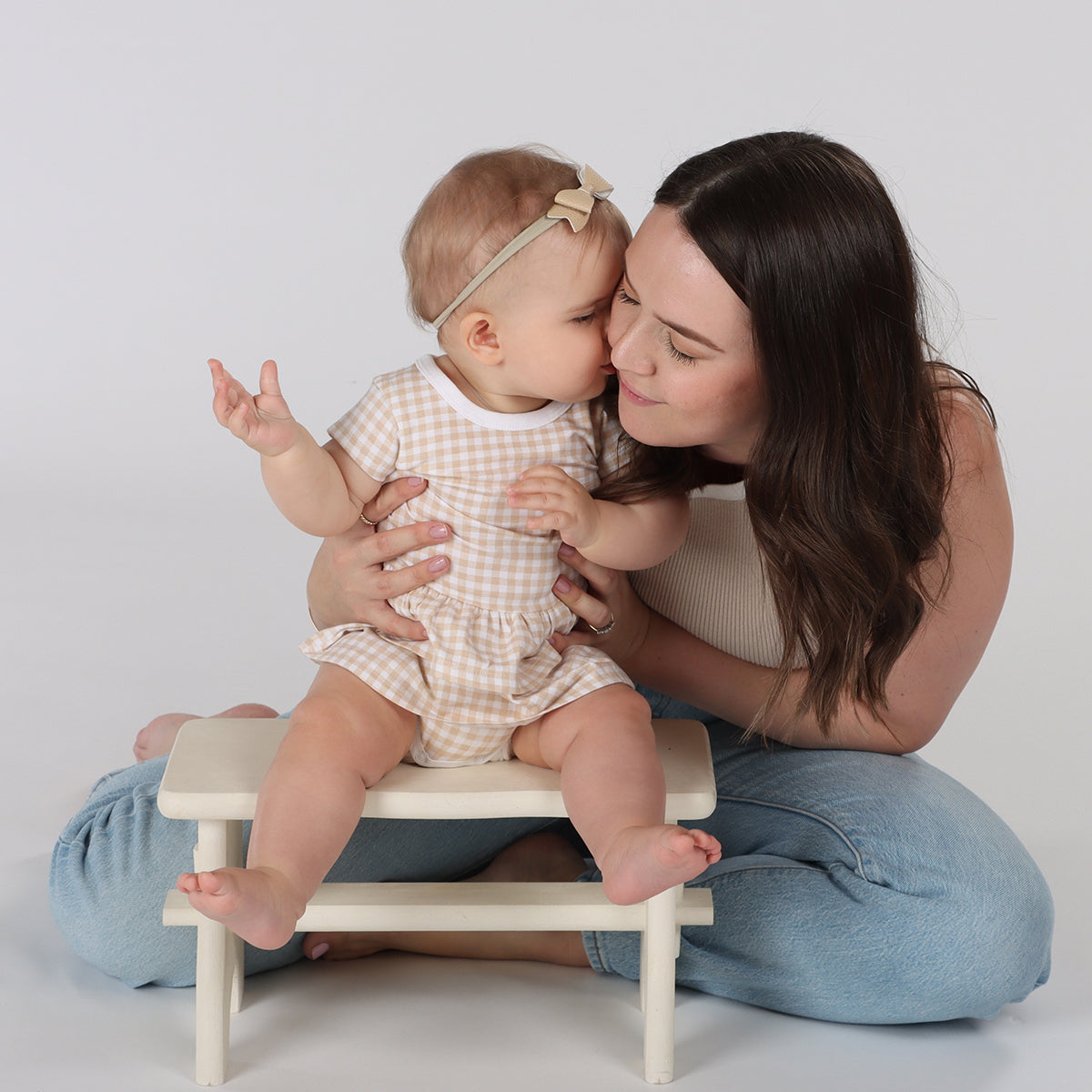 Isabell wearing Organic cotton skirt bodysuit kissing her mother 