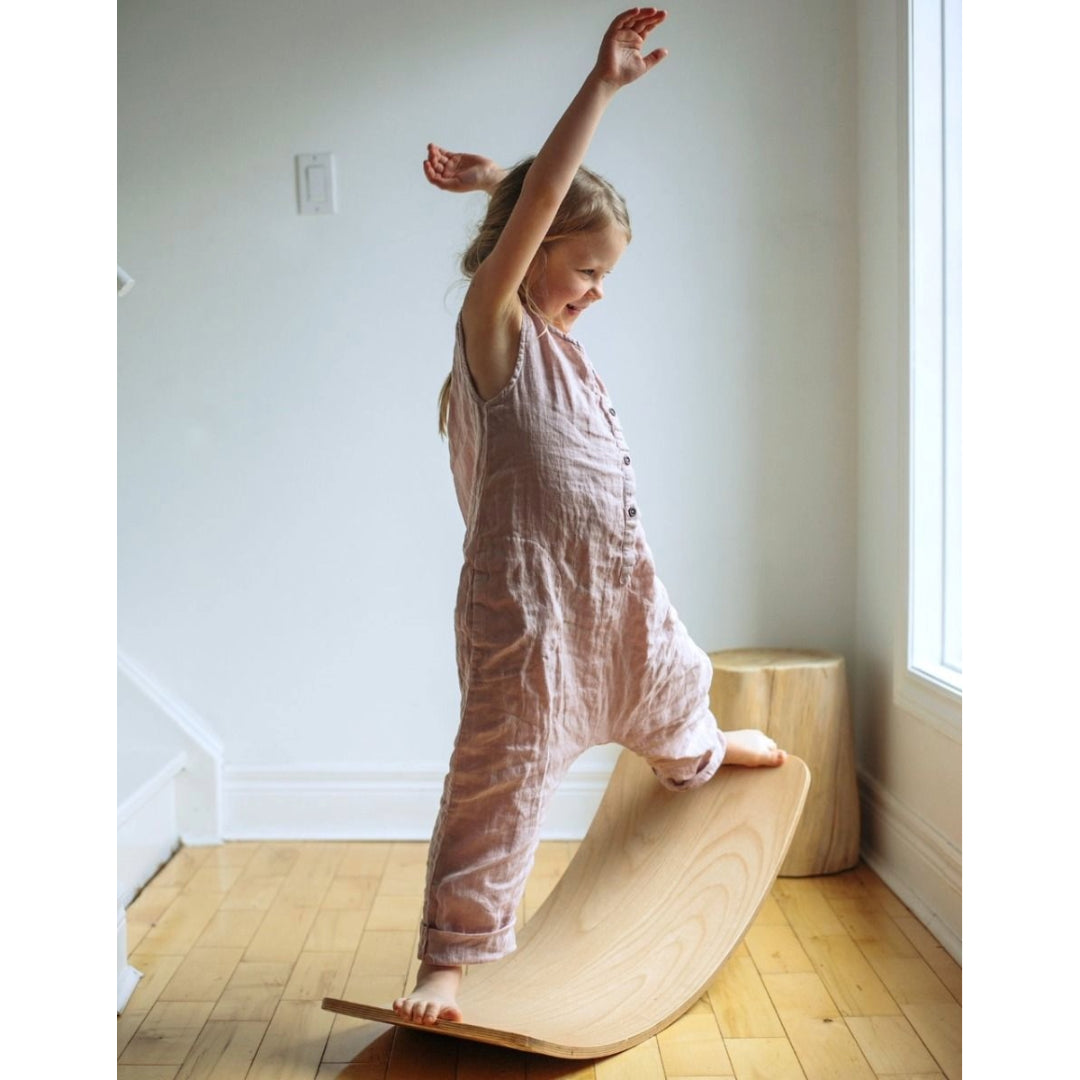 Girl toddler standing on the Kinderboard from Kinderfeets