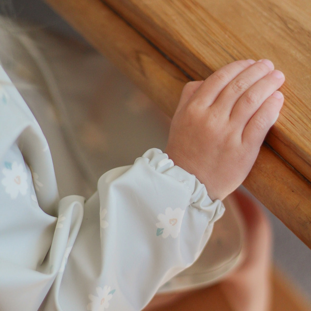 Waterproof long sleeve bib from Over the Dandelions in Daisy print