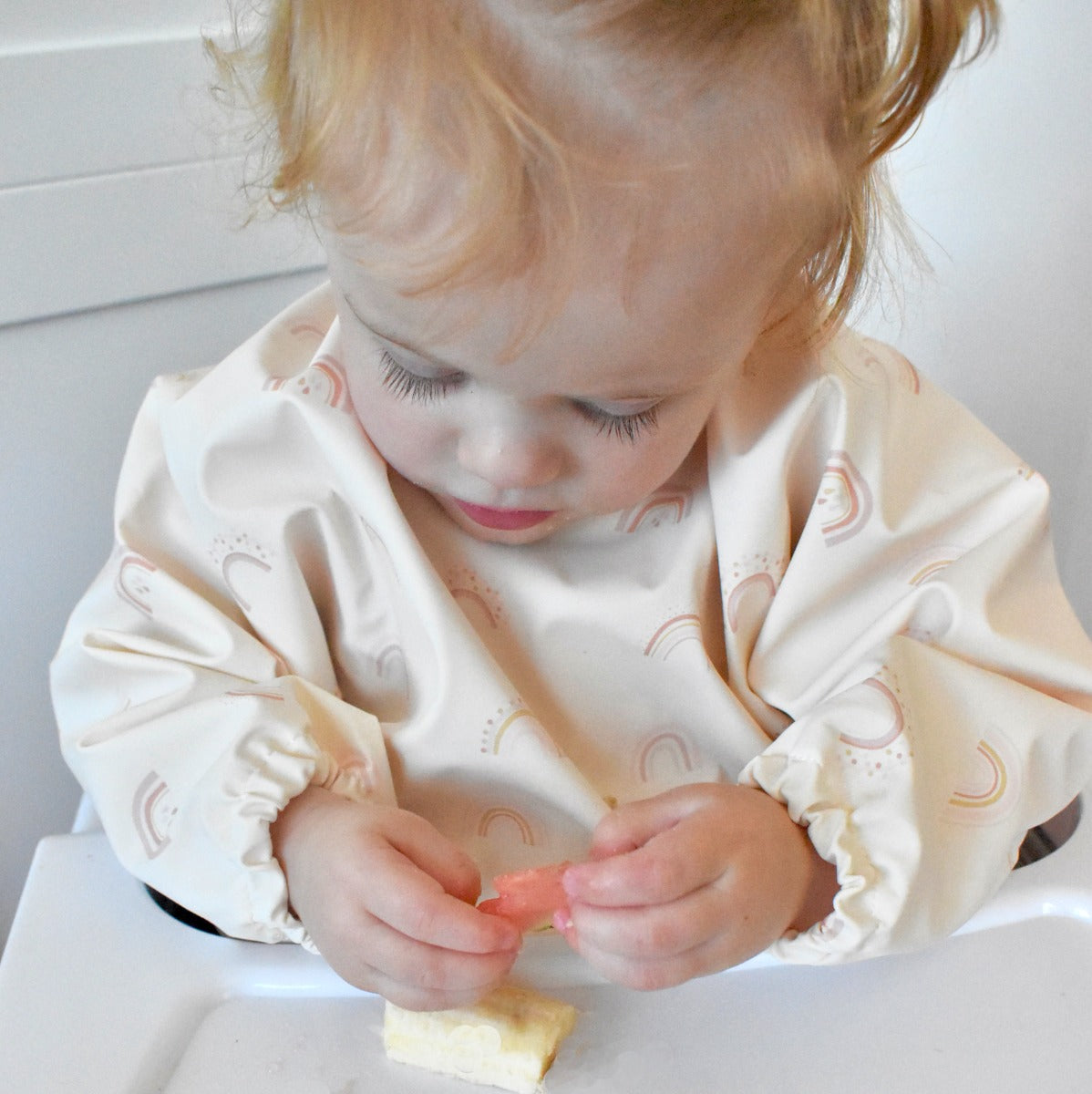 Waterproof long sleeve bib from Over the Dandelions in rainbow print