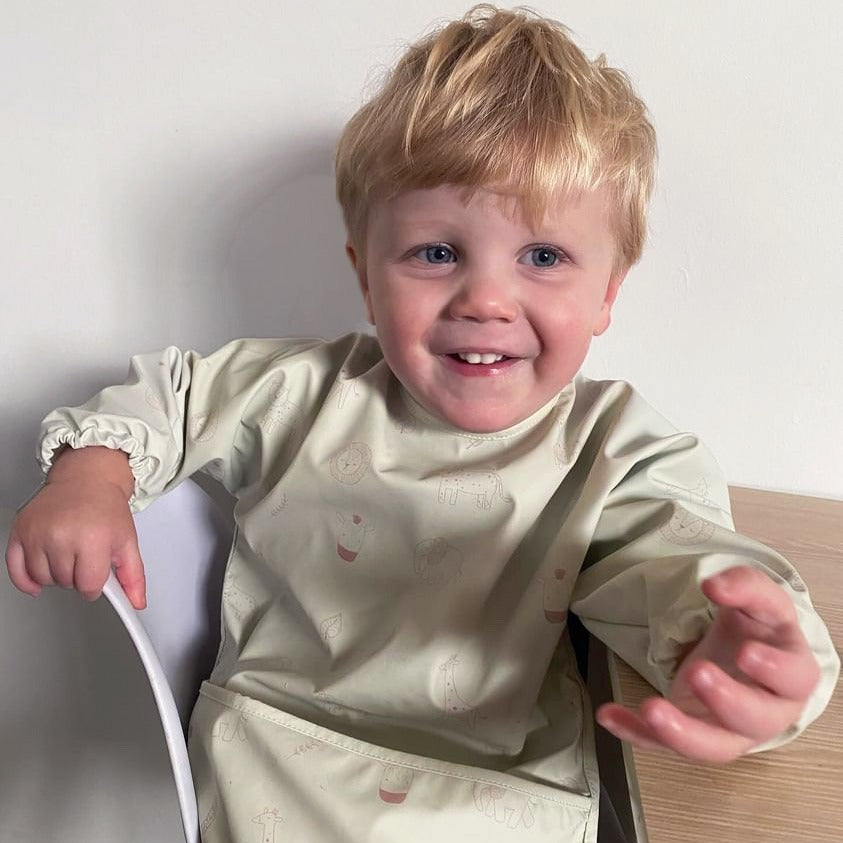 Waterproof long sleeve bib from Over the Dandelions in Dino print
