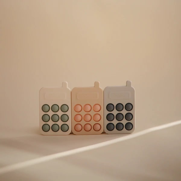 Mushie Phone Press Toy in Blush 