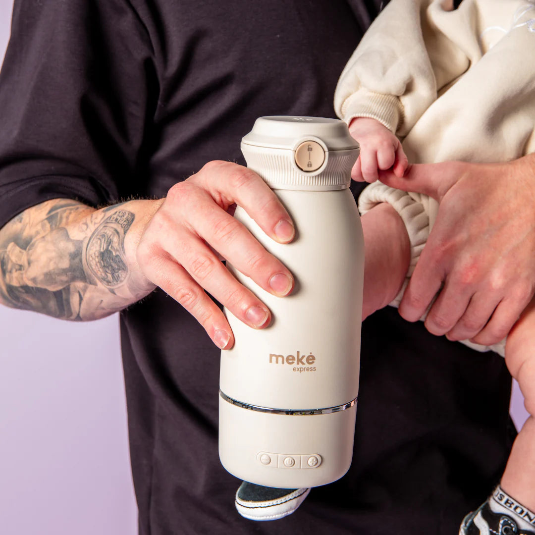 Father holding Meke Express Milk Warmer