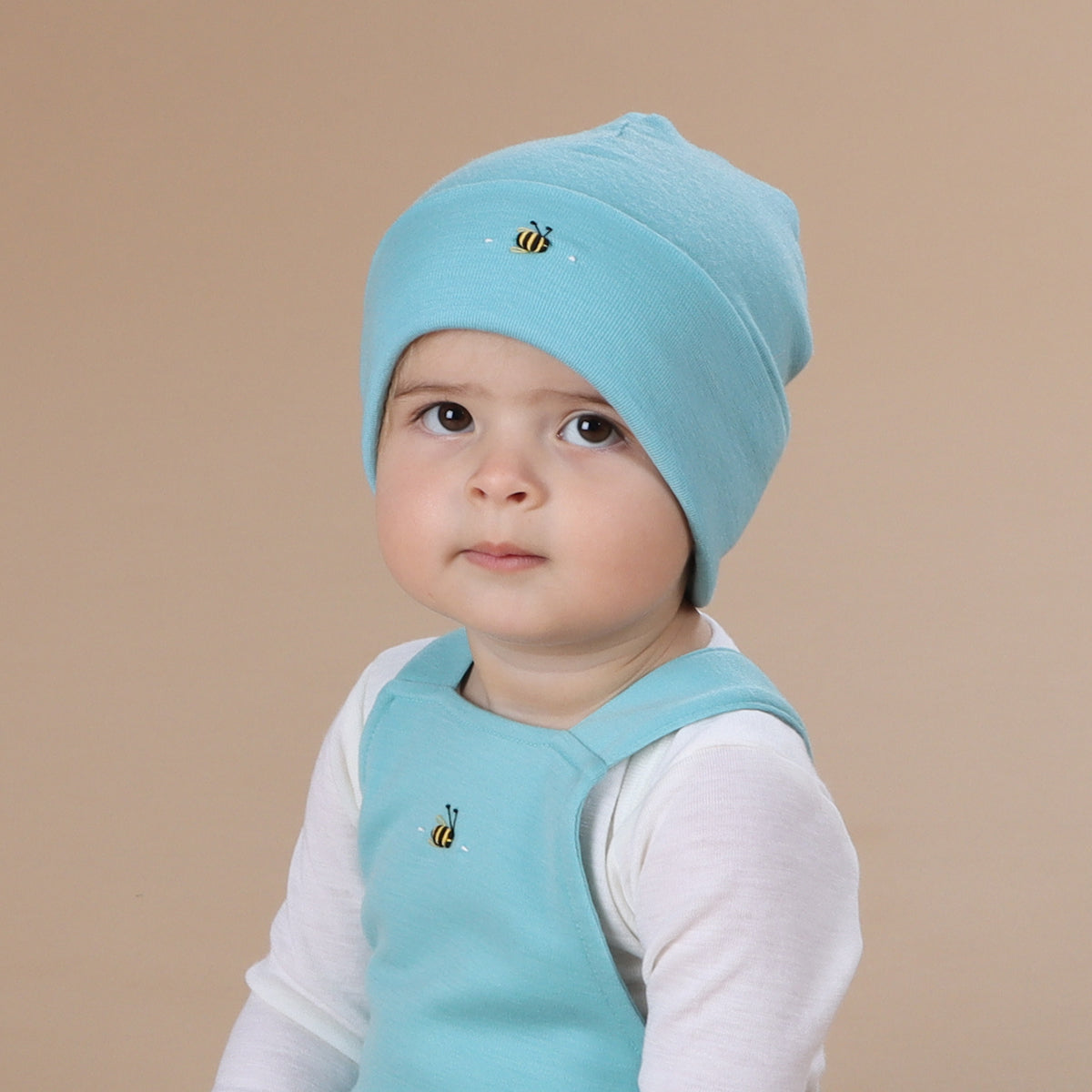 Baby wearing merino beanie with hand embroidery bee:image,small_image,thumbnail