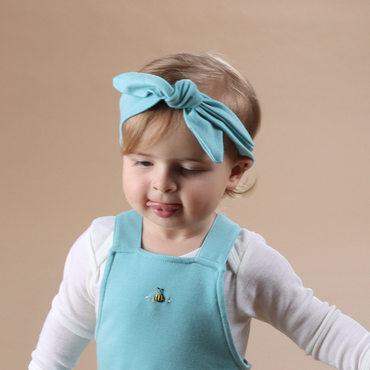 Baby wearing Merino Headband in teal