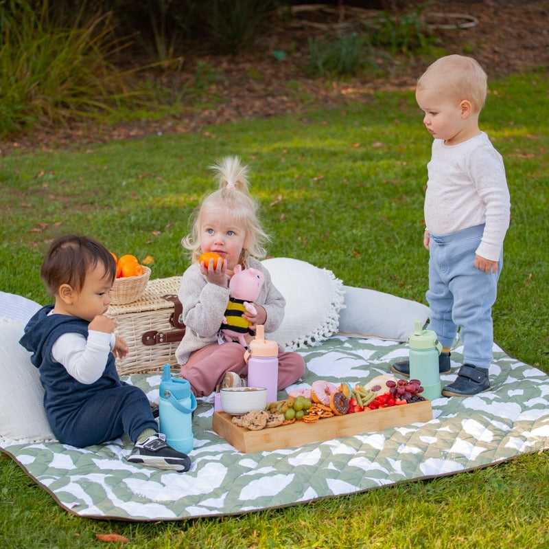 Kids sitting on  quilted playmat from Zazi