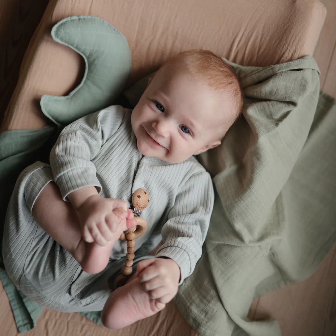 Mushie Moon Lovey Blanket in Roman Green with baby