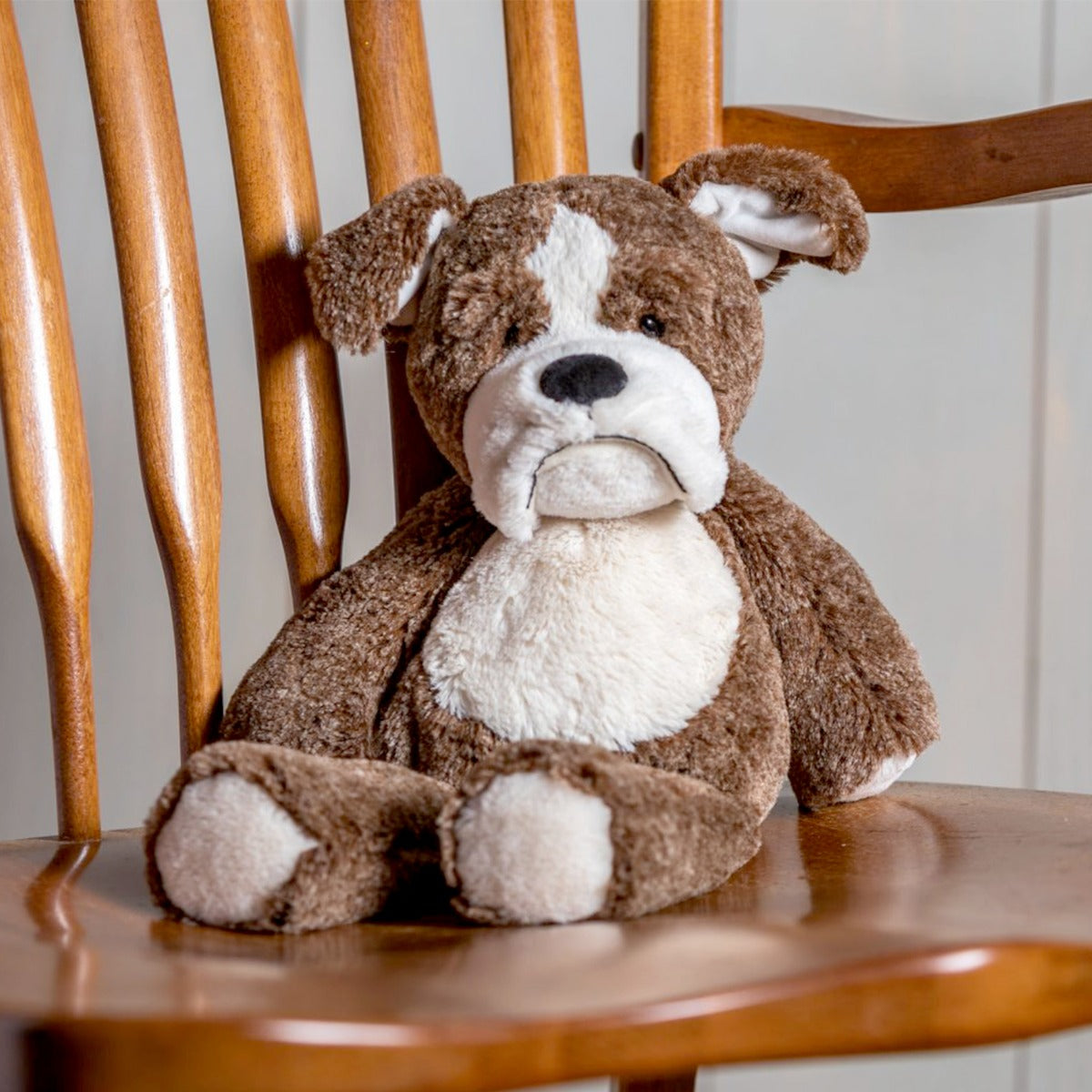 Marshmallow Bulldog soft toy from Mary Meyer front view on a chair
