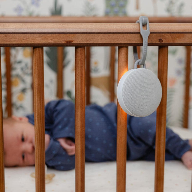 Baby lying in cot with Yogasleep Hushh 2 comforter