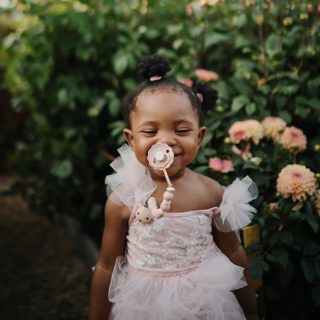 Mushie Luna Pacifier Clip in blush lifestyle
