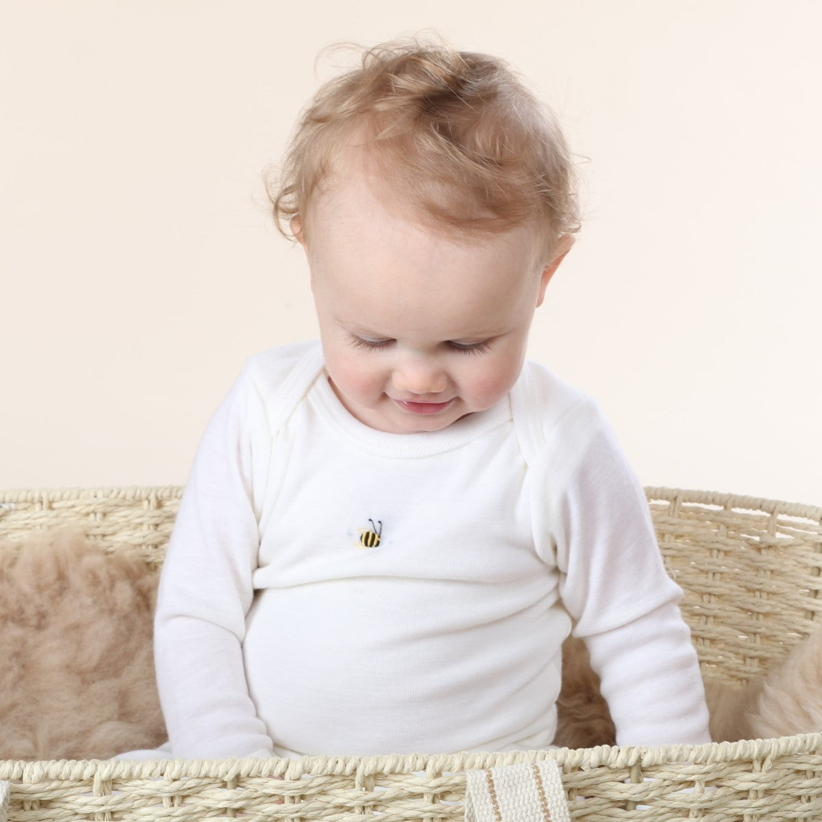 Dimples Cream Bee Merino Bodysuit on Sitting baby