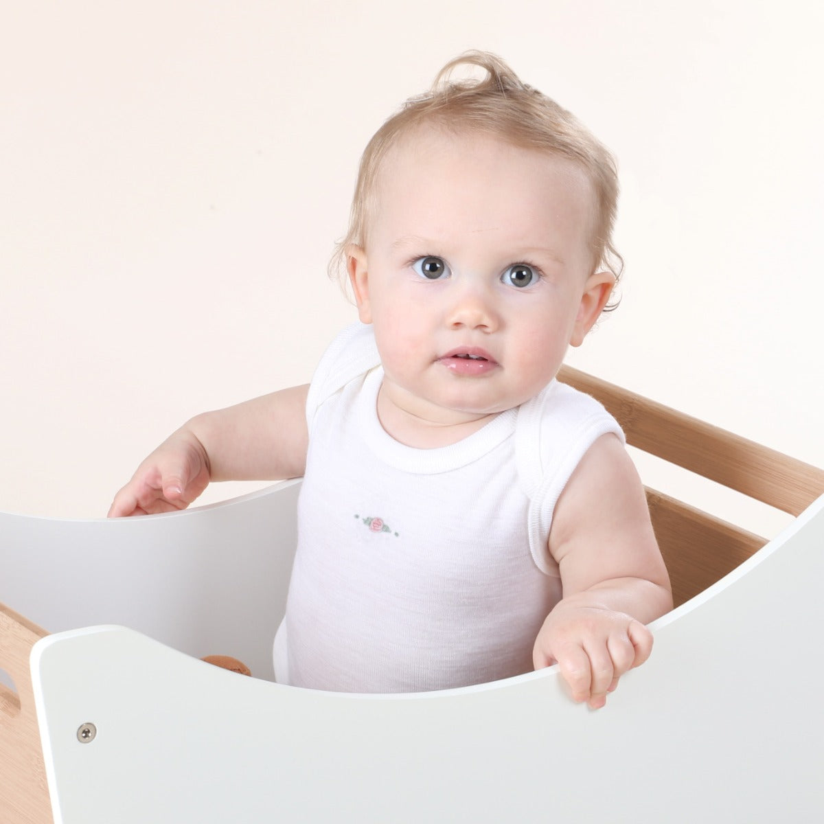 Dimples cream rose merino sleeveless bodysuit on baby 
