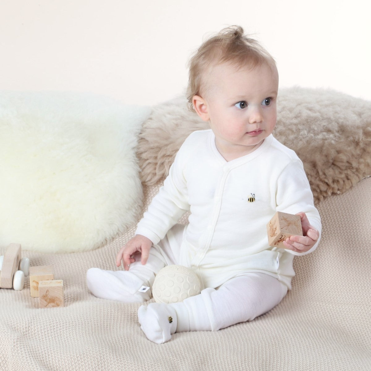 Dimples Cream bee merino cardigan on baby