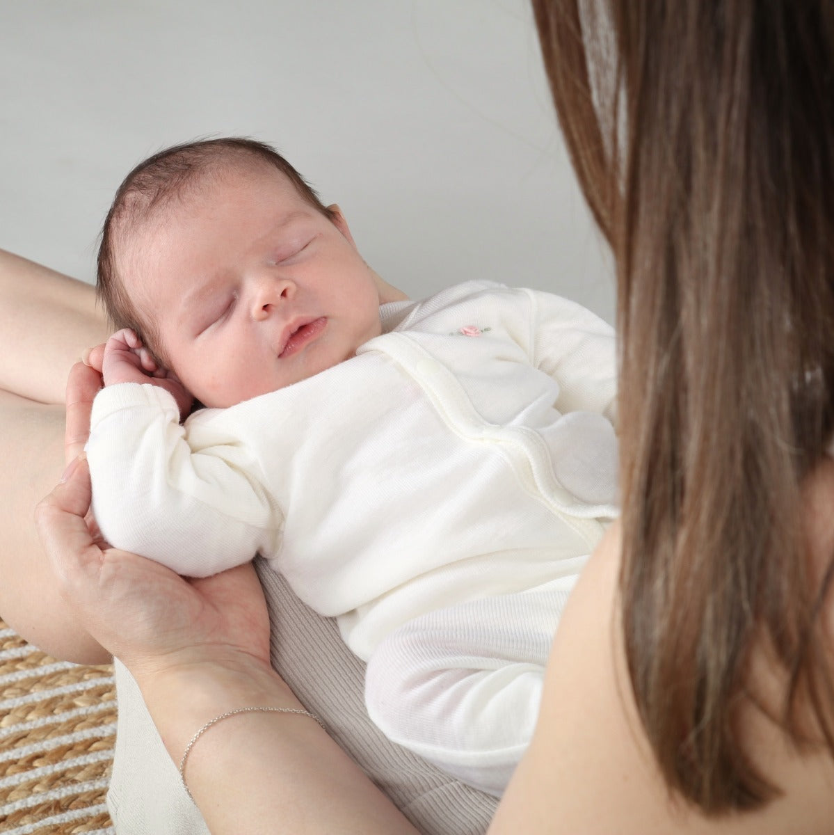 Dimples Classic merino cream rose cardigan on newborn baby