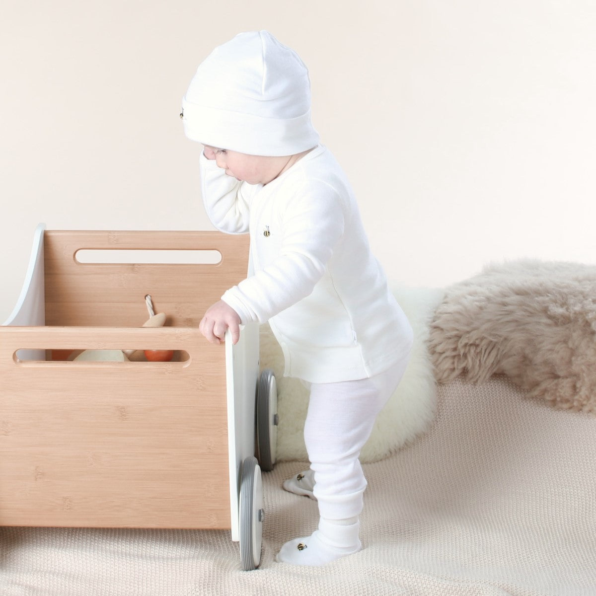 Dimples cream merino pants on standing baby 
