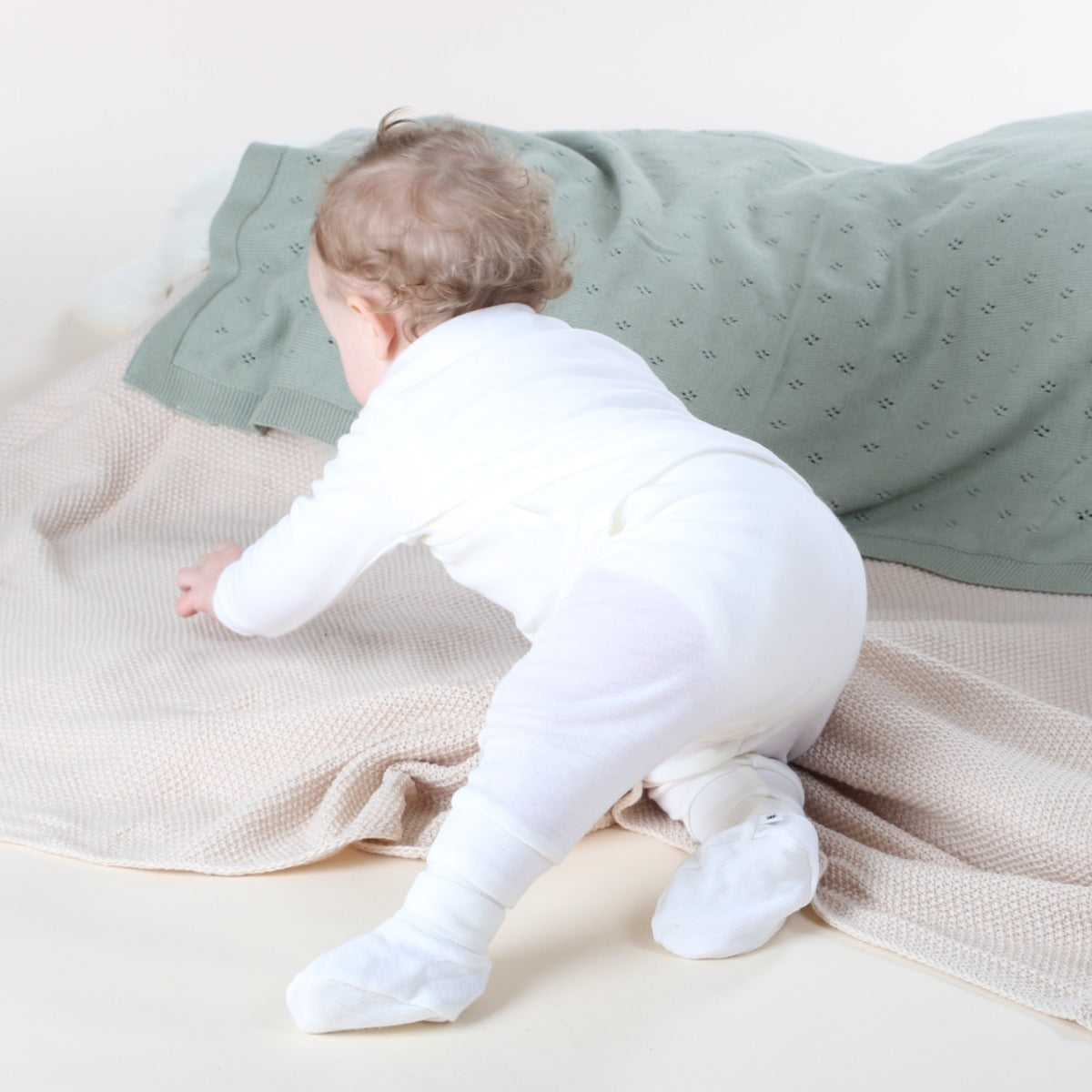 Dimples cream merino pants on Crawling baby 