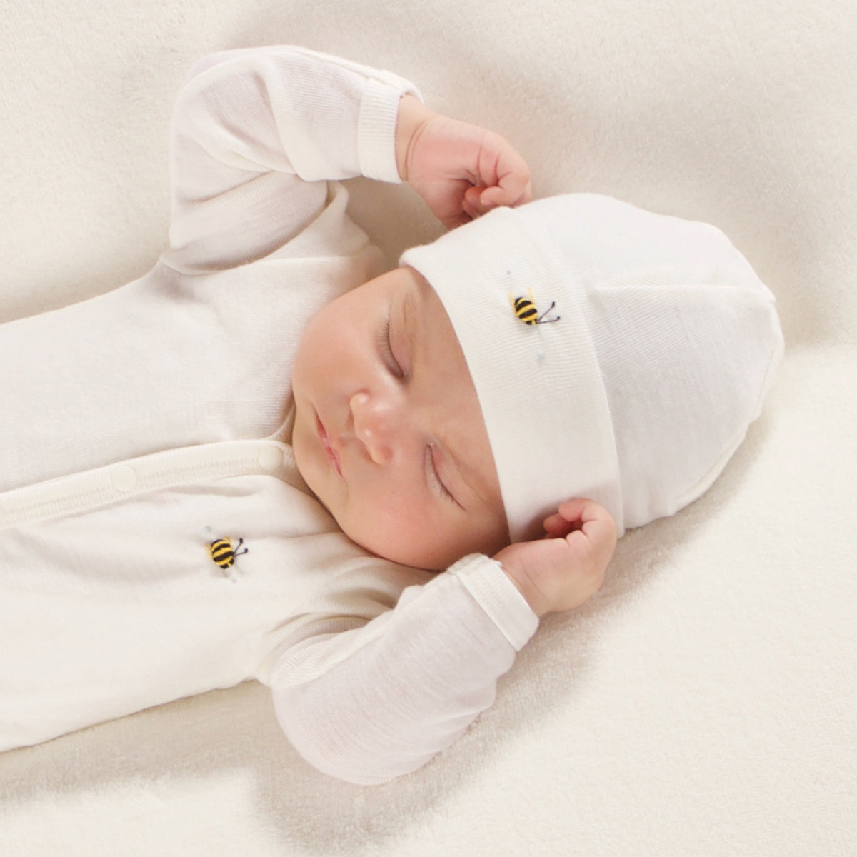 Dimples Cream Bee merino beanie on Sleeping baby
