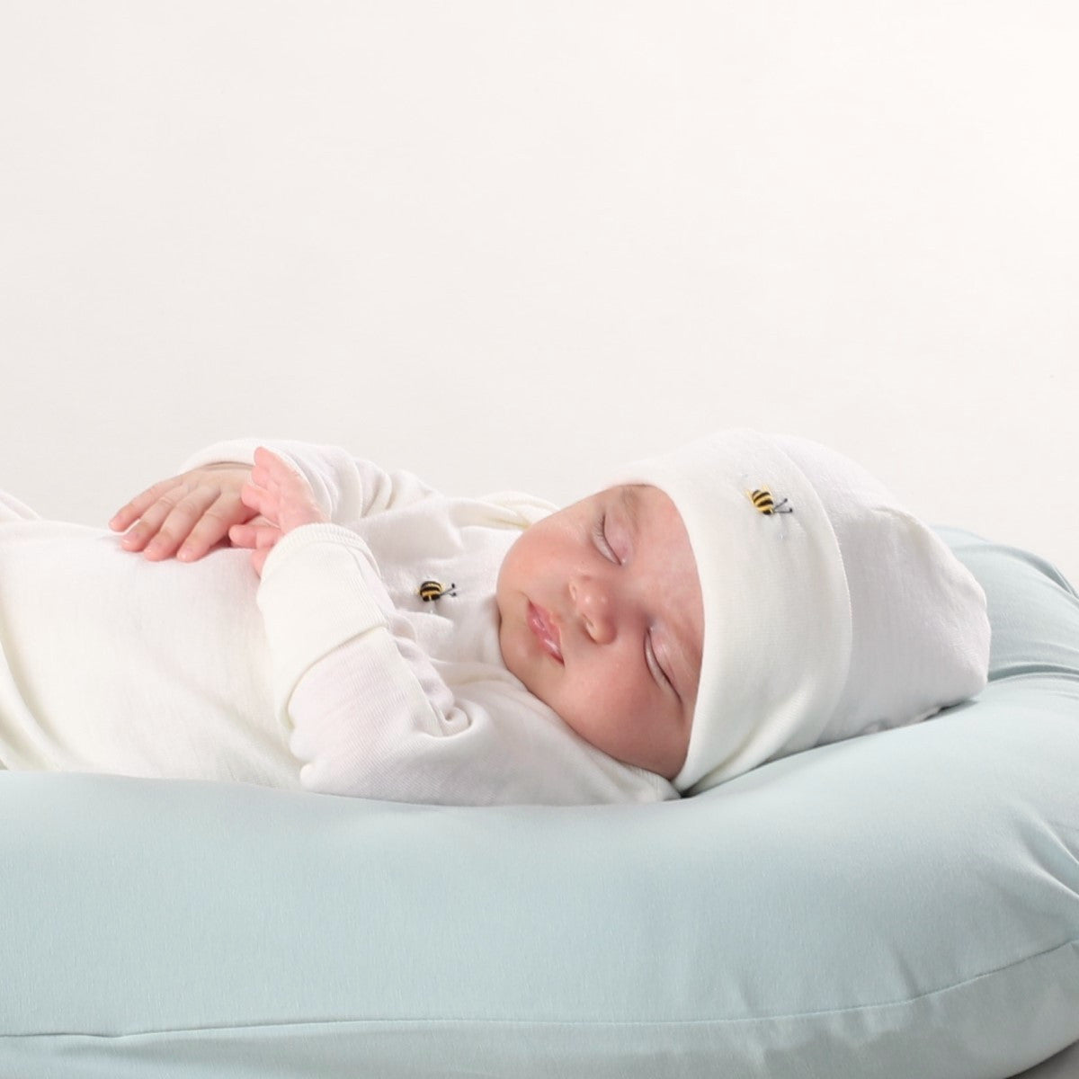 Dimples Cream Bee merino beanie on Sleeping baby