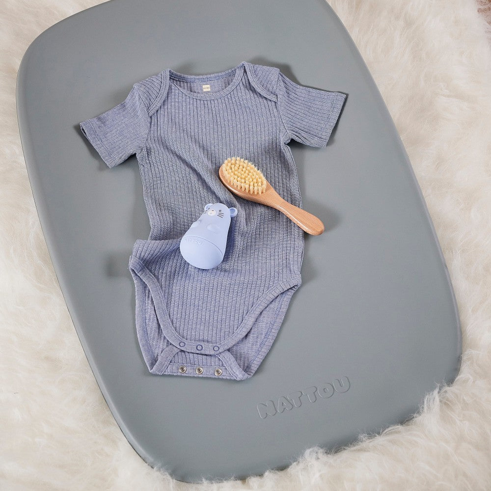 Getting ready essentials for baby on Baby Change Mat from Nattou in grey