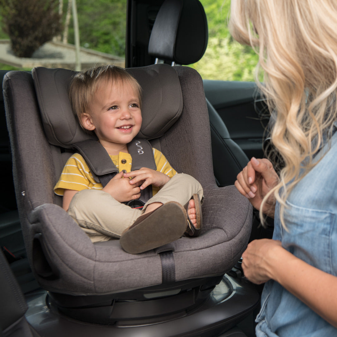 Mother putting baby in Todl Next Car Seat safely and easily in a car