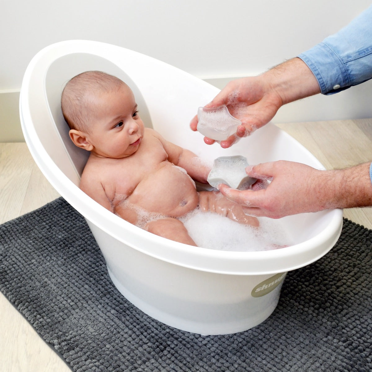 Baby bathing in Snuggle baby bath