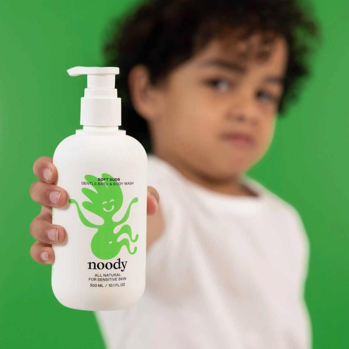 Baby holding Soft Clouds bath and body wash