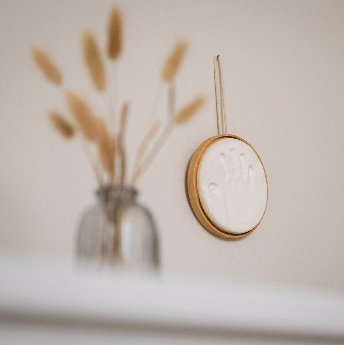 Baby handprint on hypoallergic clay in wooden hanging
