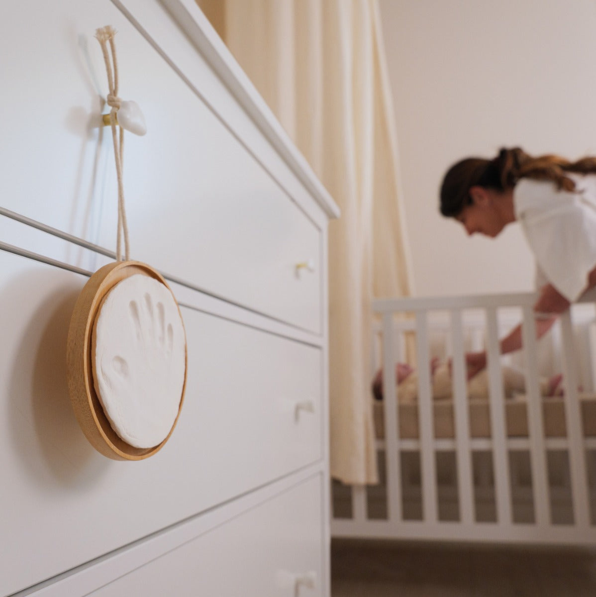Baby handprint on hypoallergic clay in wooden hanging