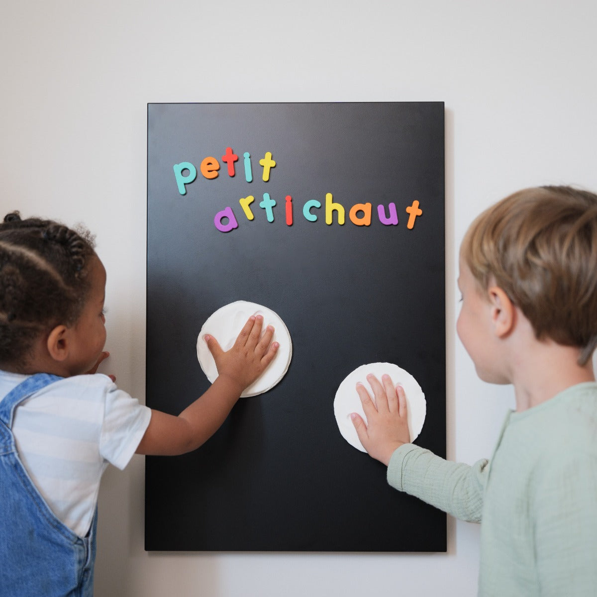 Petit Artichaut 2 Magnetic Keepsakes sibling hand print on a board