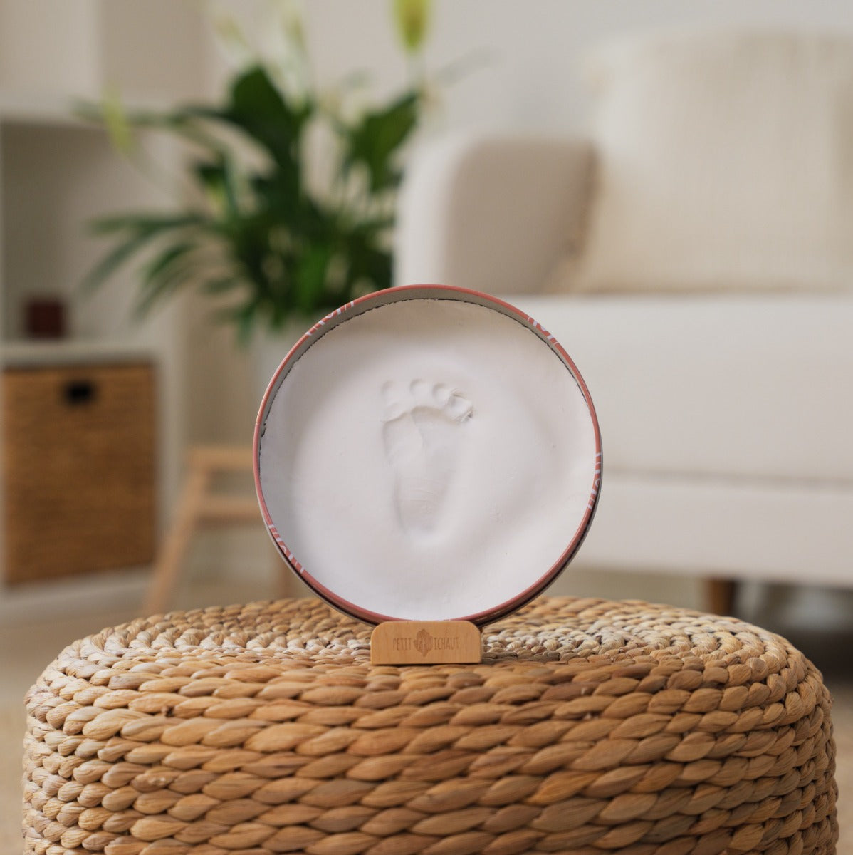 Petite artichaut baby box round in rainbow terracotta sitting on a small table/seat
