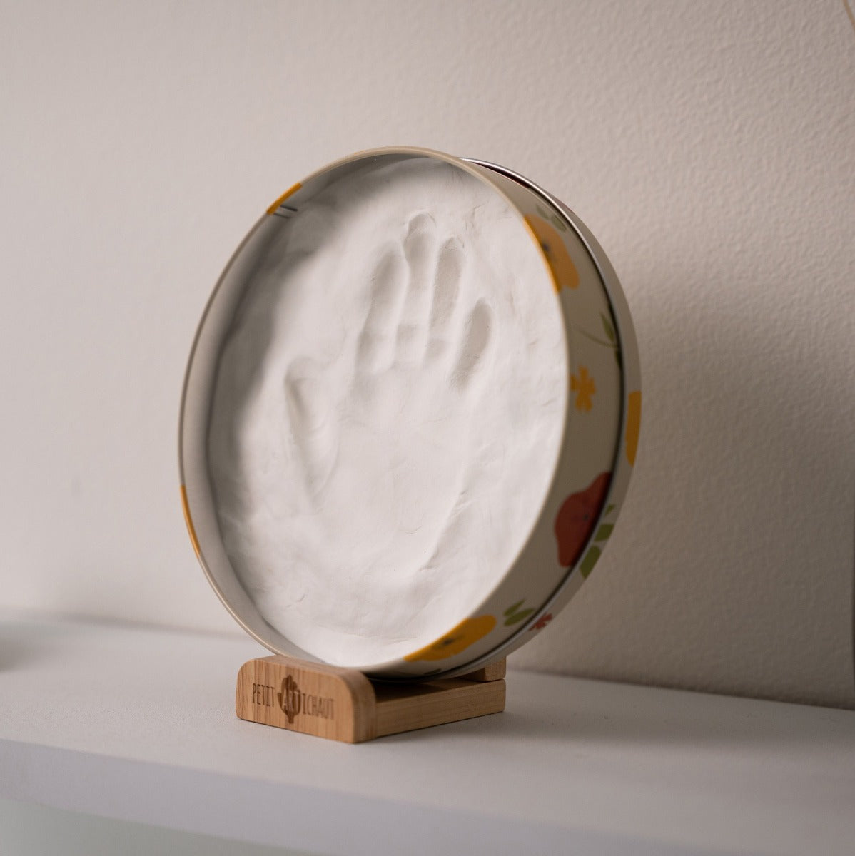 Petit Artichaut baby box round in little prairie print placed on a dresser