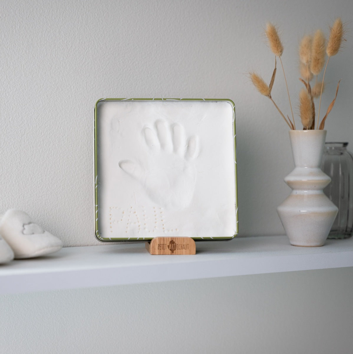 Petit Artichaut baby box square in olive tree print hand print on dresser