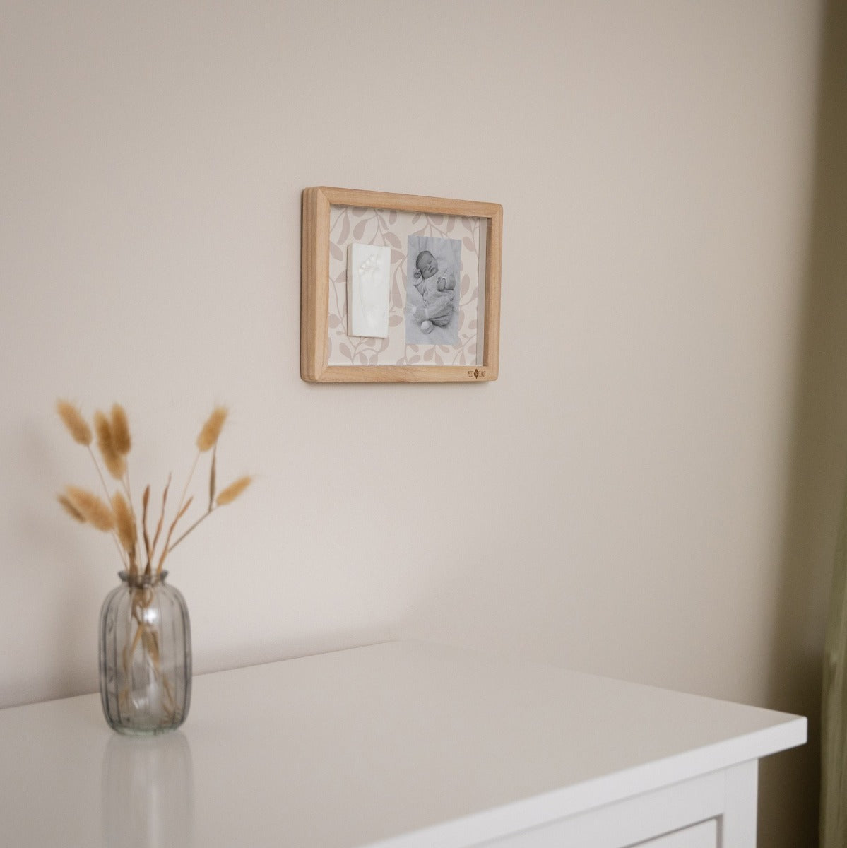 Petit Artichaut Classic frame with Ivy Grey Print hung from a wall above a dresser