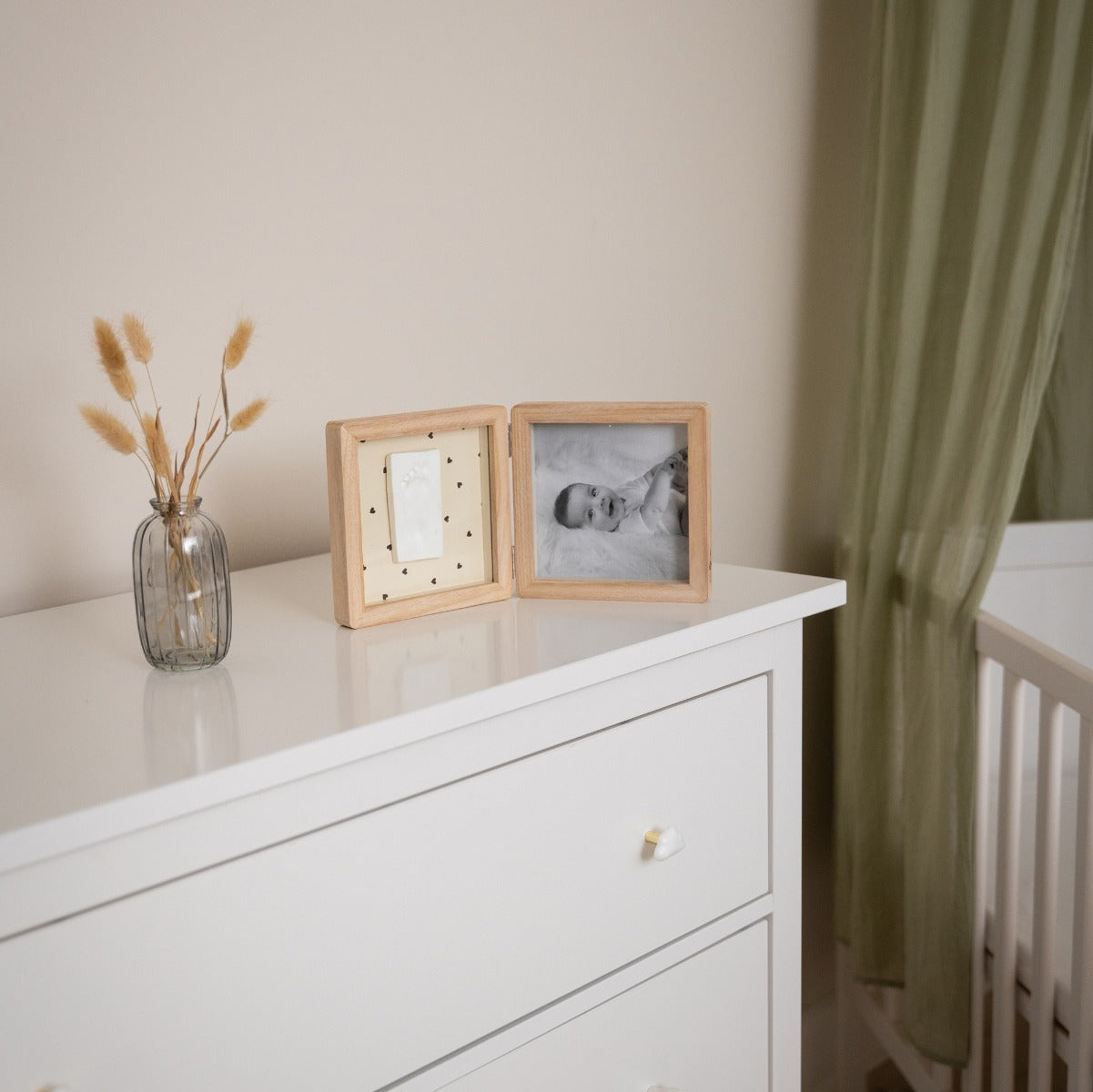 Petit Artichaut Double Frame Pretty hearts print placed on a dresser beside cot