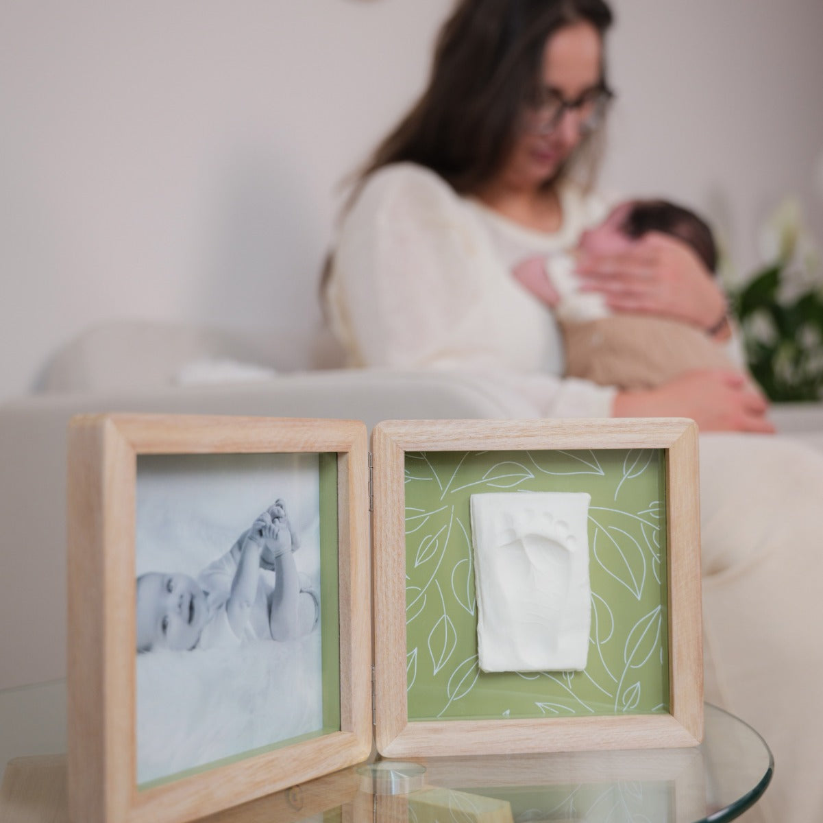 Petit Artichaut double frame olive tree print placed on little table in front of mother and baby 