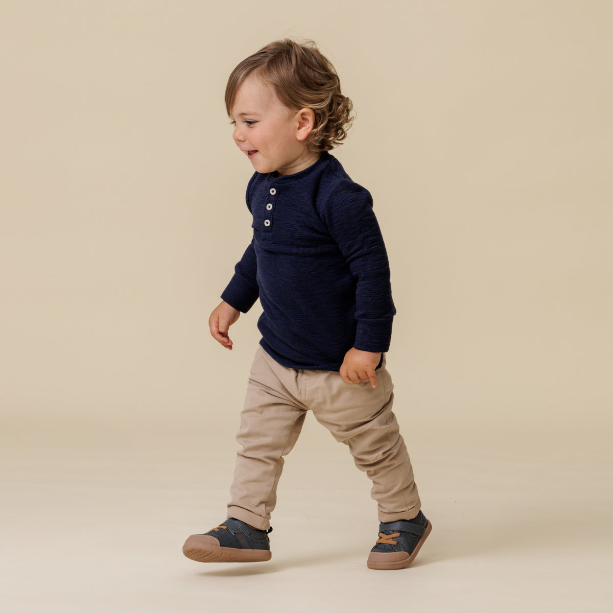 Baby walking, wearing 1st walker indigo shoes