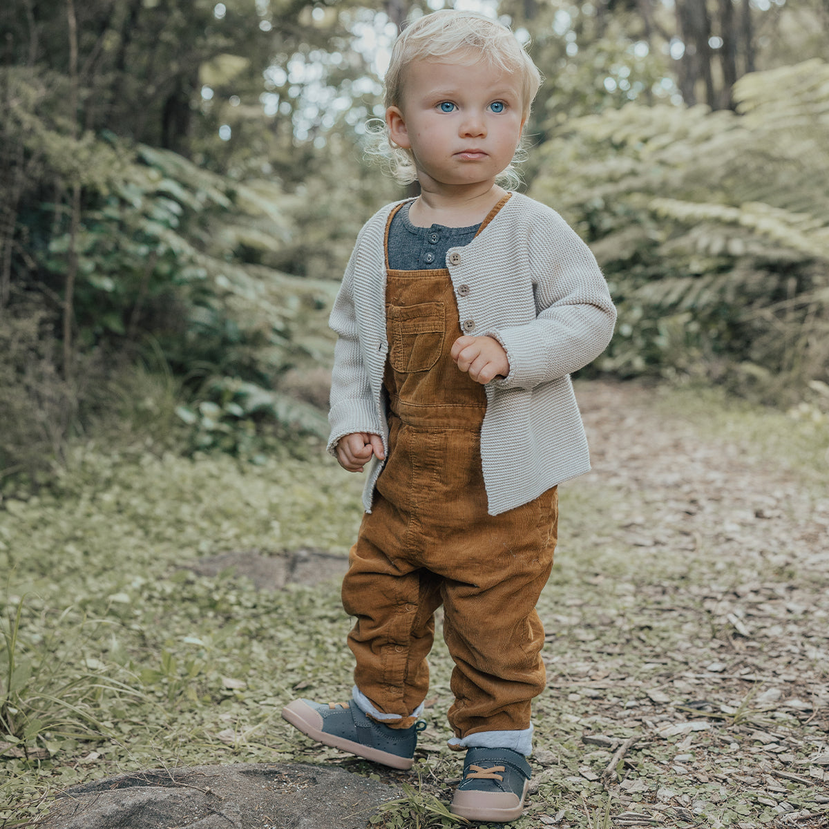 Baby in a park wearing 1st walker indigo shoes