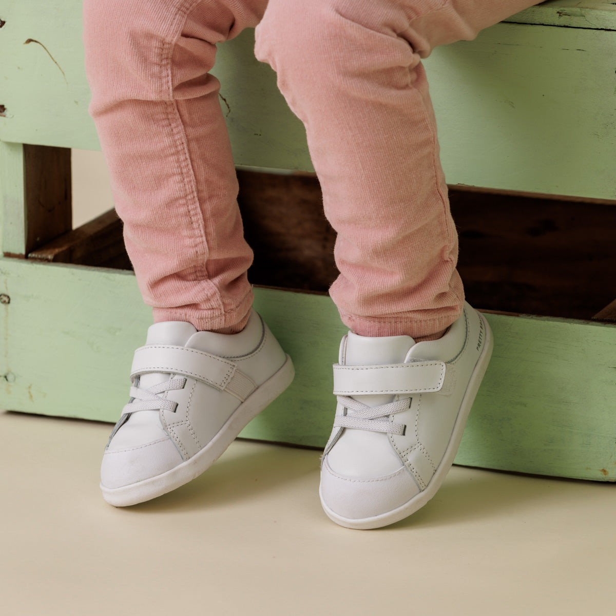 Baby wearing 1st walker white shoes