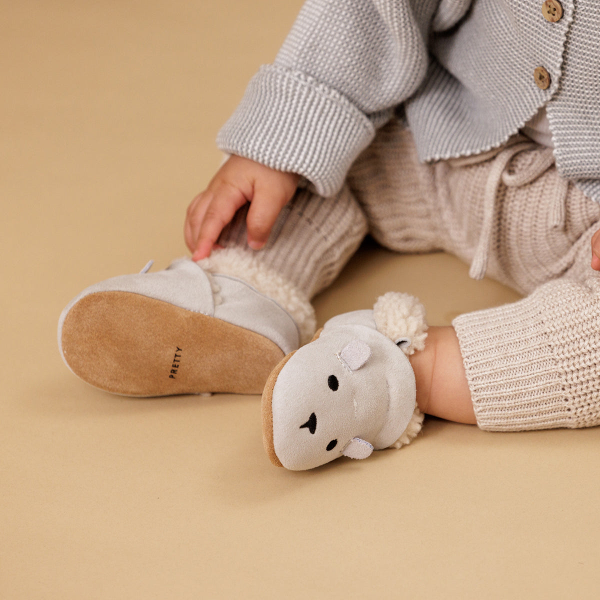 Baby wearing winter cosy fur baby shoes