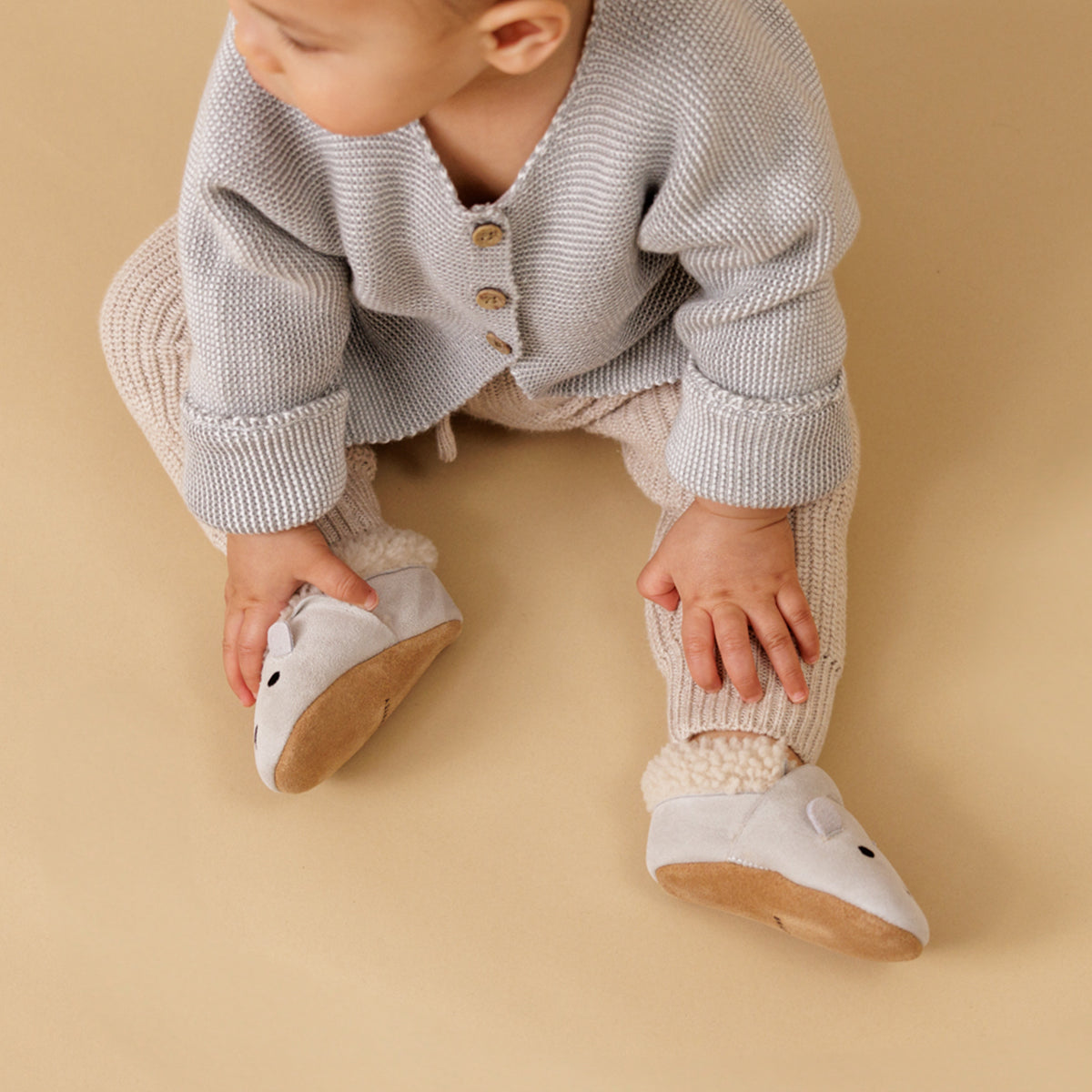 Baby wearing winter cosy fur baby shoes