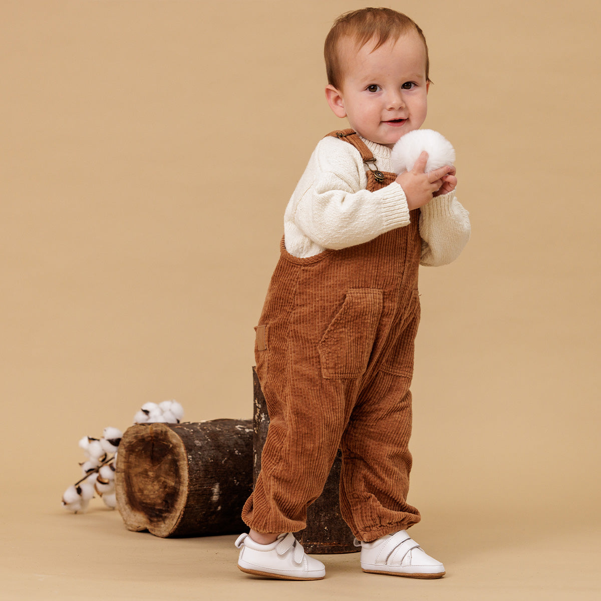 baby wearing white leather shoes