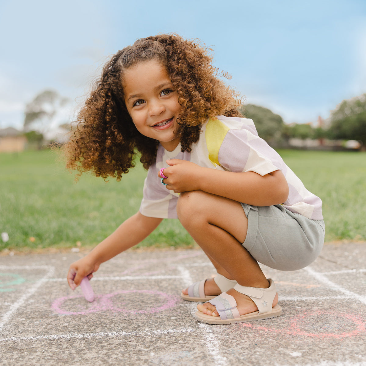 Little girl wearing Pretty Brave Baby Star Sandal in Sparkle