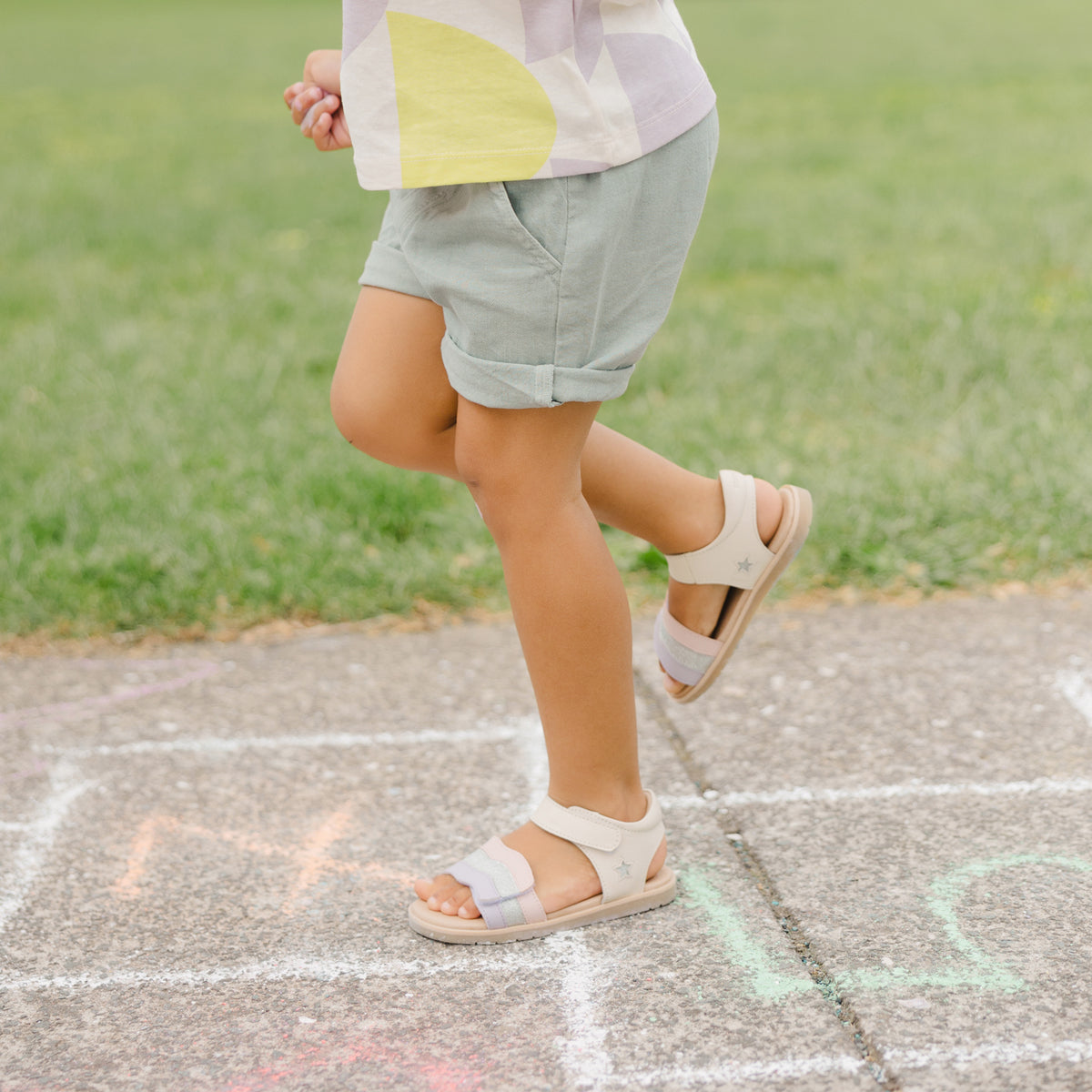 Little girl wearing Pretty Brave Baby Star Sandal in Sparkle