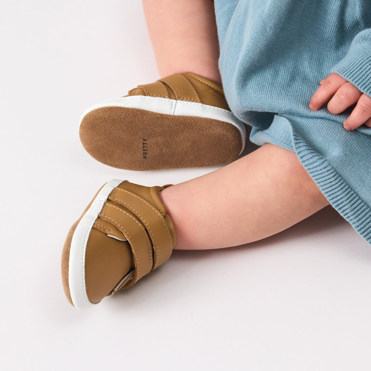 Unisex Baby Scout in tan from Pretty Brave on a baby feet