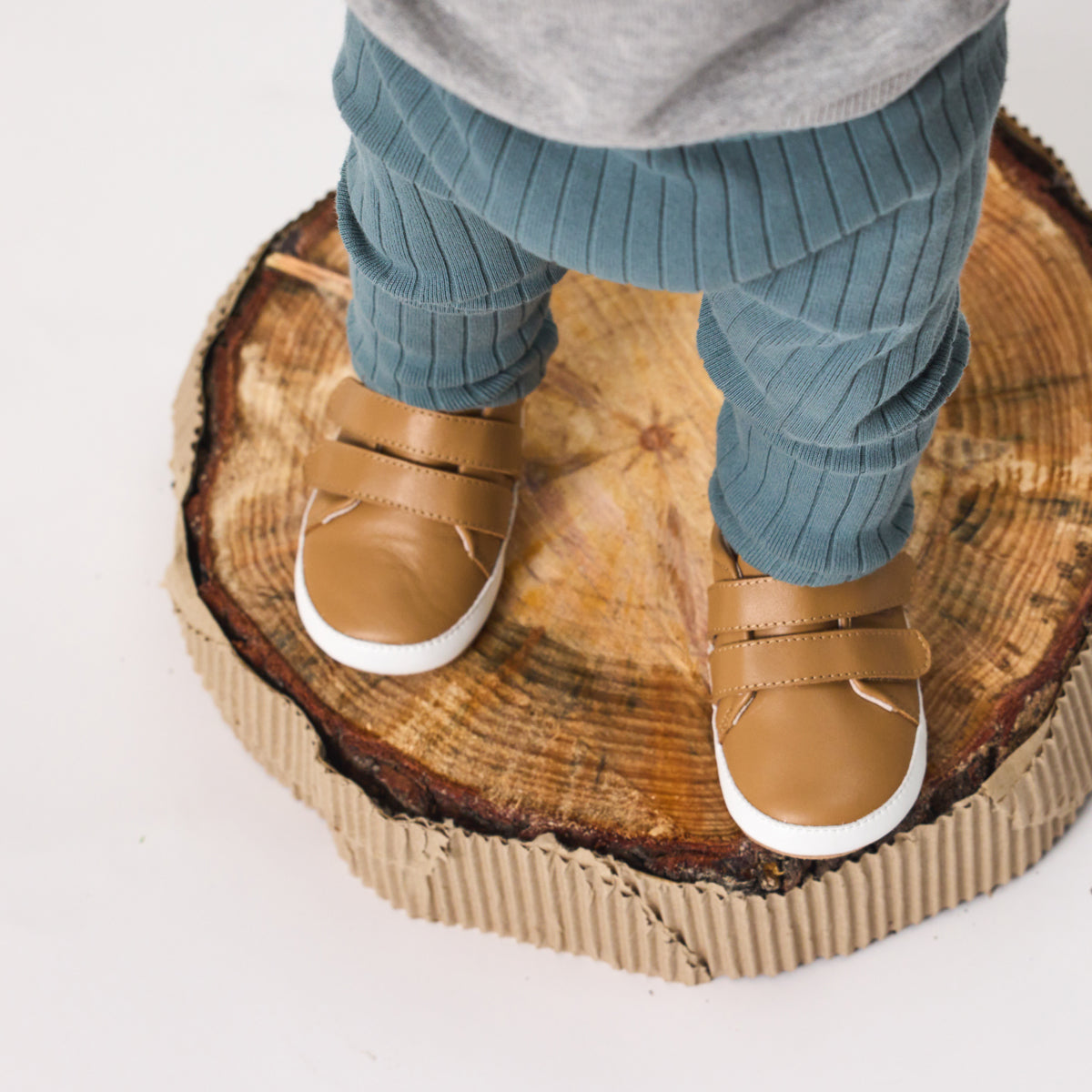 Unisex Baby Scout in tan from Pretty Brave on a baby feet